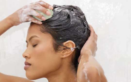 shampoo bar on hair in shower