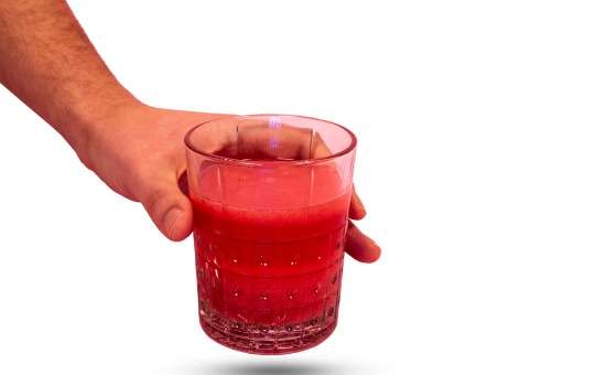 holding mixed drink of colon broom