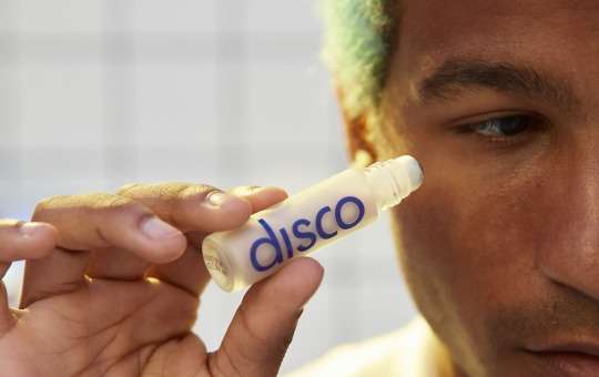man applying disco eye stick cream
