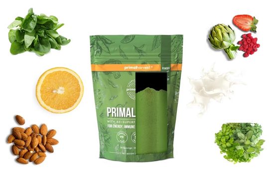Ingredients surrounding a primal greens bag that is exposed to see the powder inside.