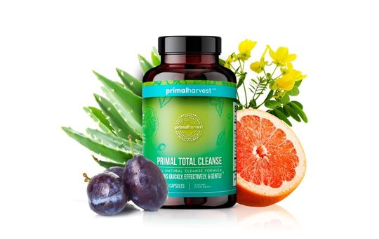 Fruit in the background of a bottle of primal total cleanse