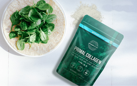 Bowl of spinach next to a bag of primal harvest collagen